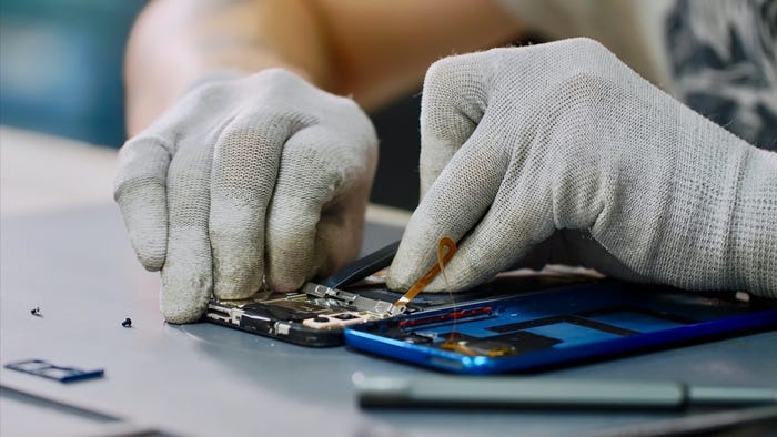 tech hands working on smartphone replacing parts refurbished
